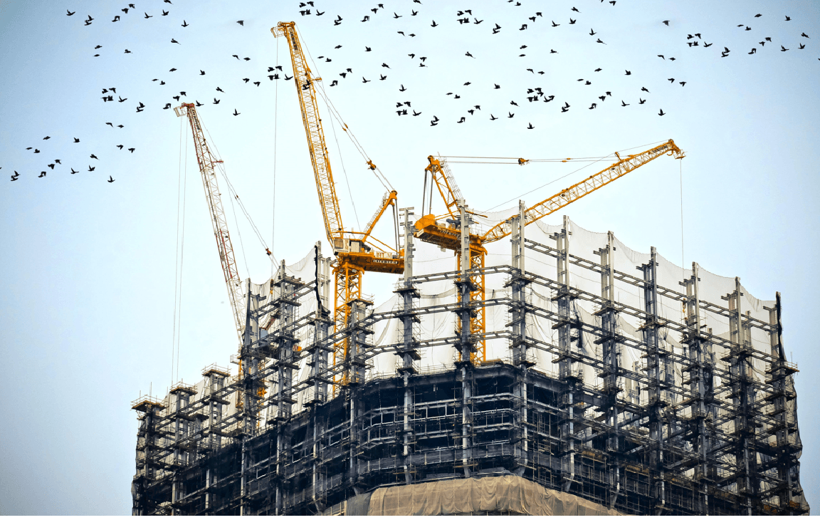 High-rise construction site with tower cranes — construction insurance